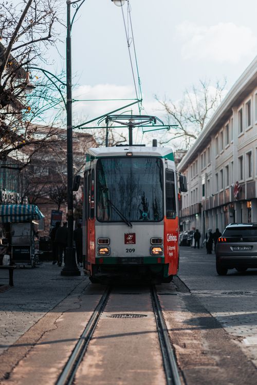 Free Tram navigating a bustling street in Bursa, capturing urban life and architecture. Stock Photo