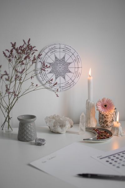 Candle and crystals beside wheel of the year