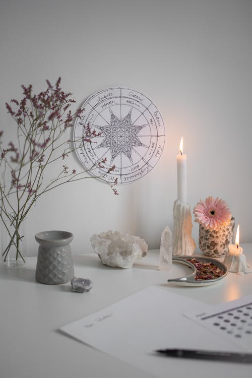 Free Burning Candle and Crystals by Wheel of Year on Wall Stock Photo