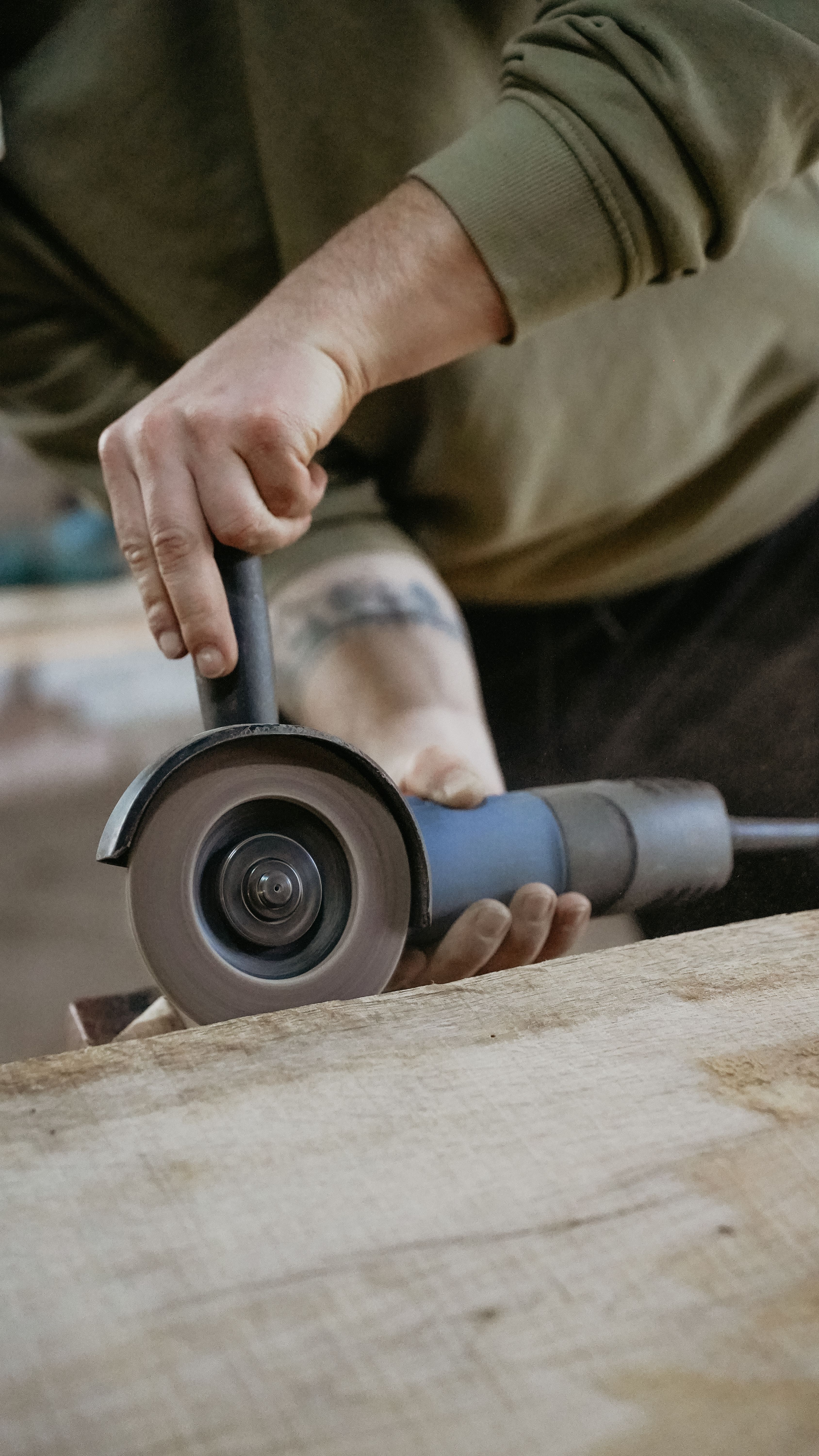Man Hand Holding Saw over Wood · Free Stock Photo