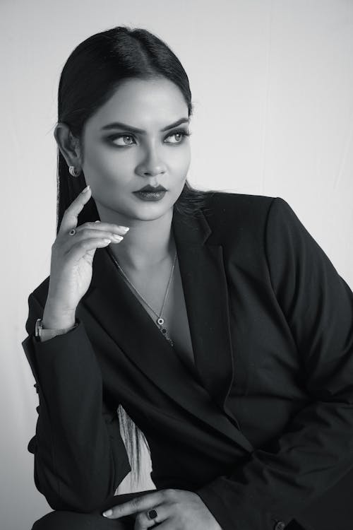 A black and white photo of a woman in a suit