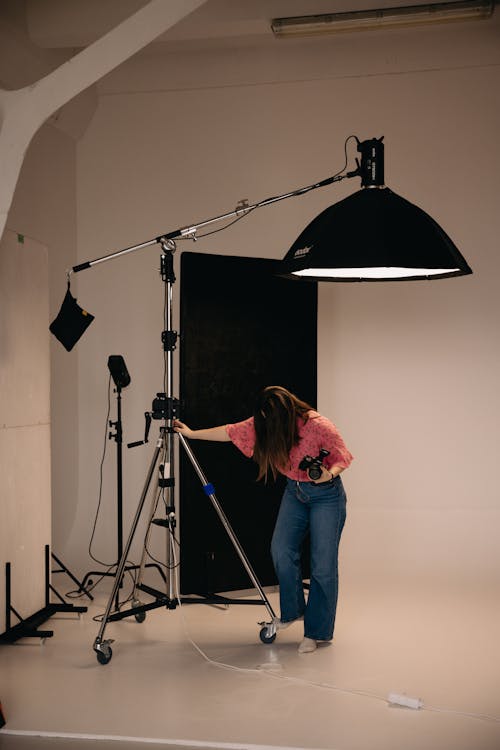 A woman standing in front of a camera in a studio