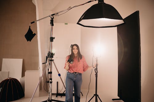 A woman standing in front of a light stand