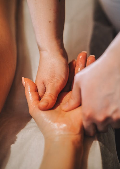 A person getting a massage with hands on their back