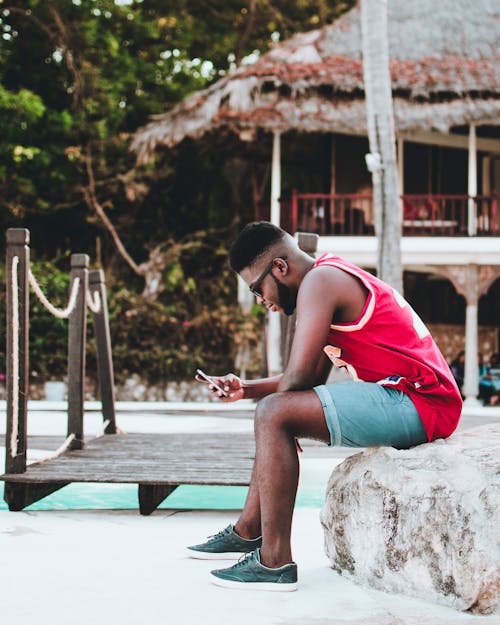 Man Sitting Down on Rock