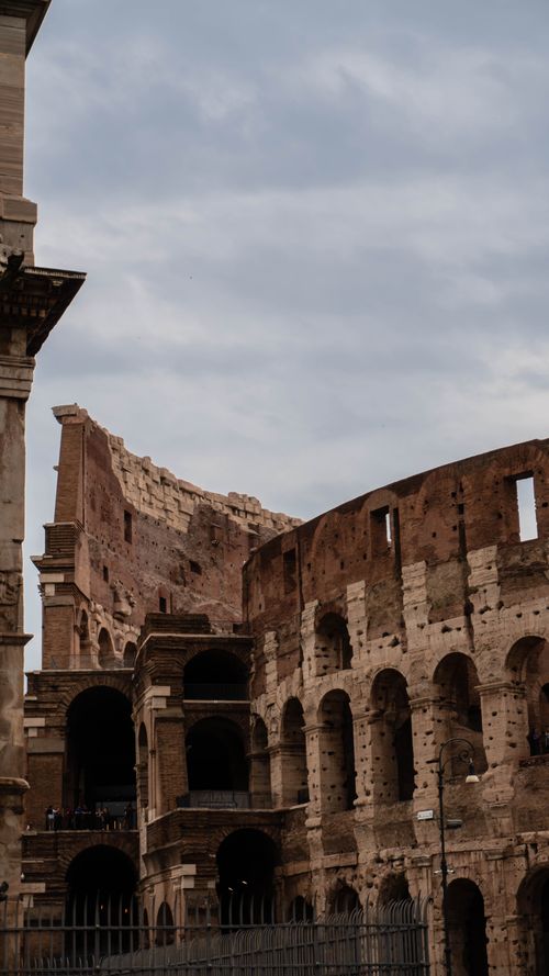 Free Explore the timeless beauty and grandeur of Rome's iconic Colosseum, capturing its historic architectural wonder. Stock Photo