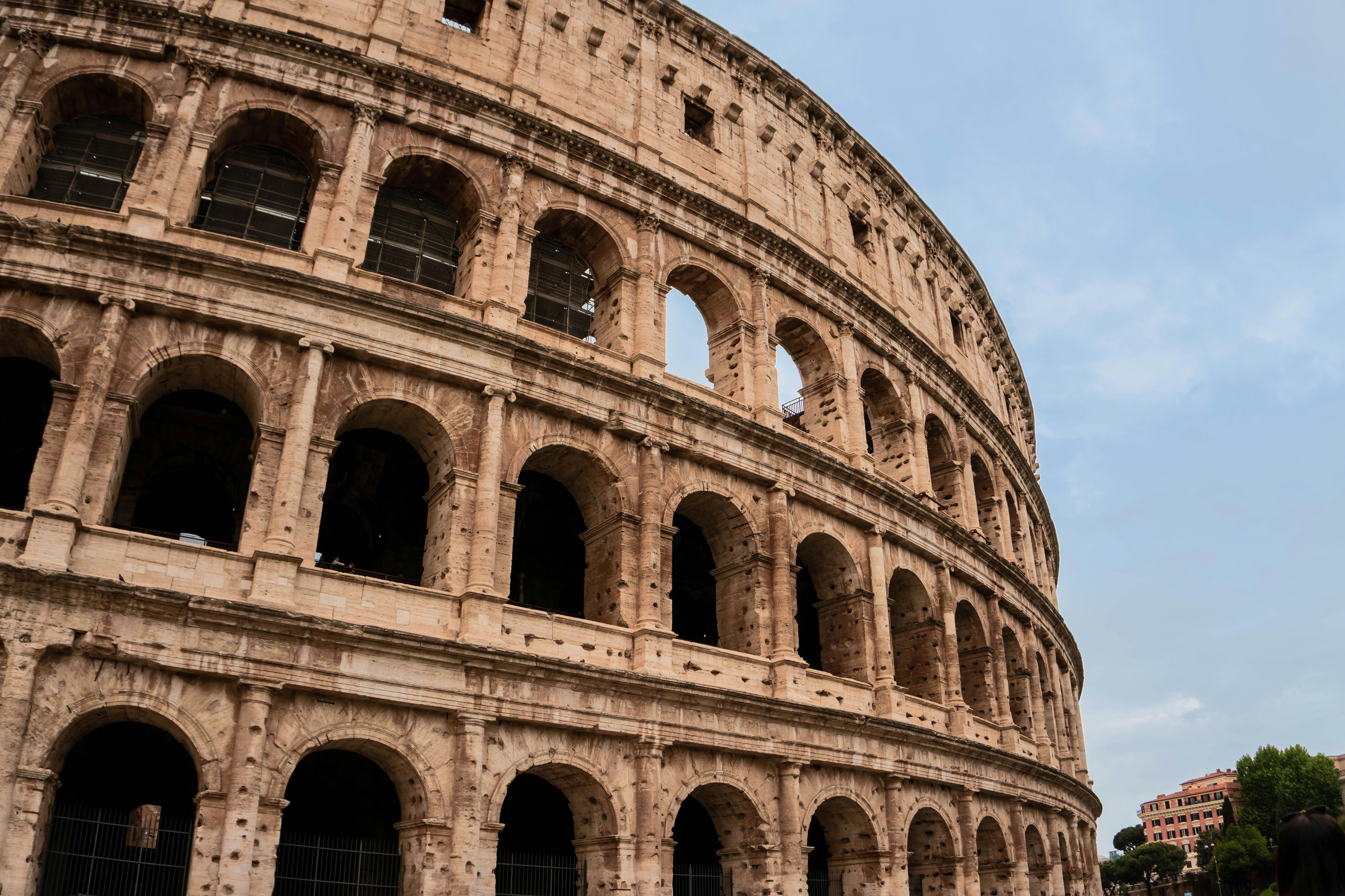 Free Capture of the iconic Colosseum with clear skies in Rome, symbolizing ancient architecture. Stock Photo