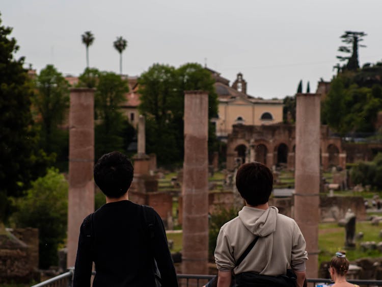 Two People Standing In Front Of A Building