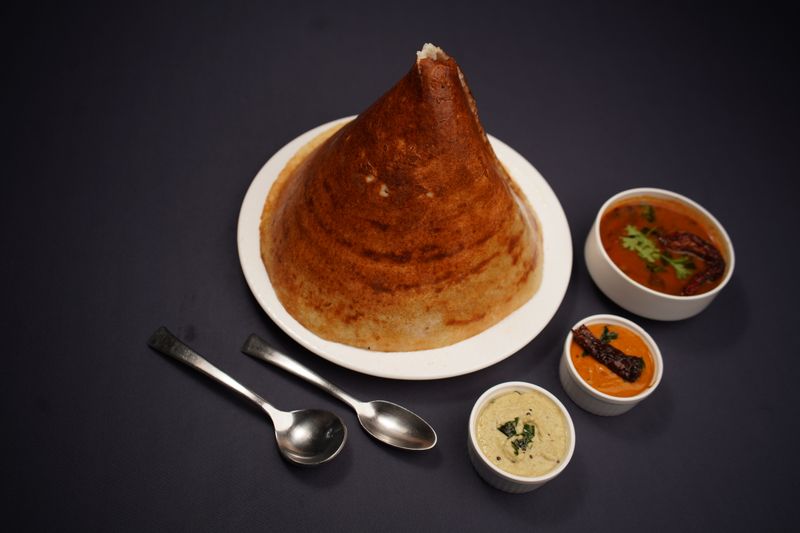 Crispy cone dosa served with chutneys and sambar