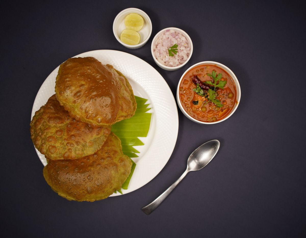 Poori with chana masala and condiments