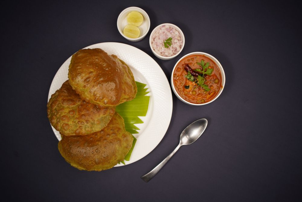 Crisp golden Poori with potato masala curry