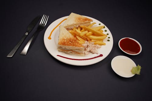 A plate with a sandwich and french fries