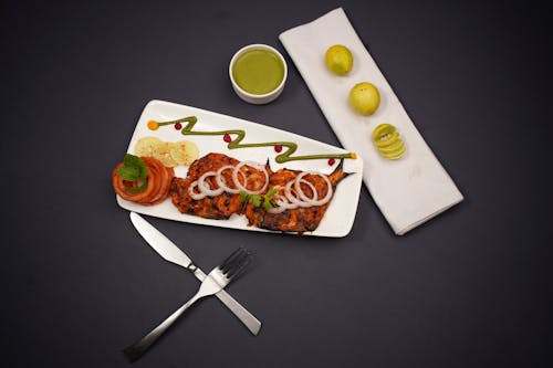 A plate with food on it and a knife and fork