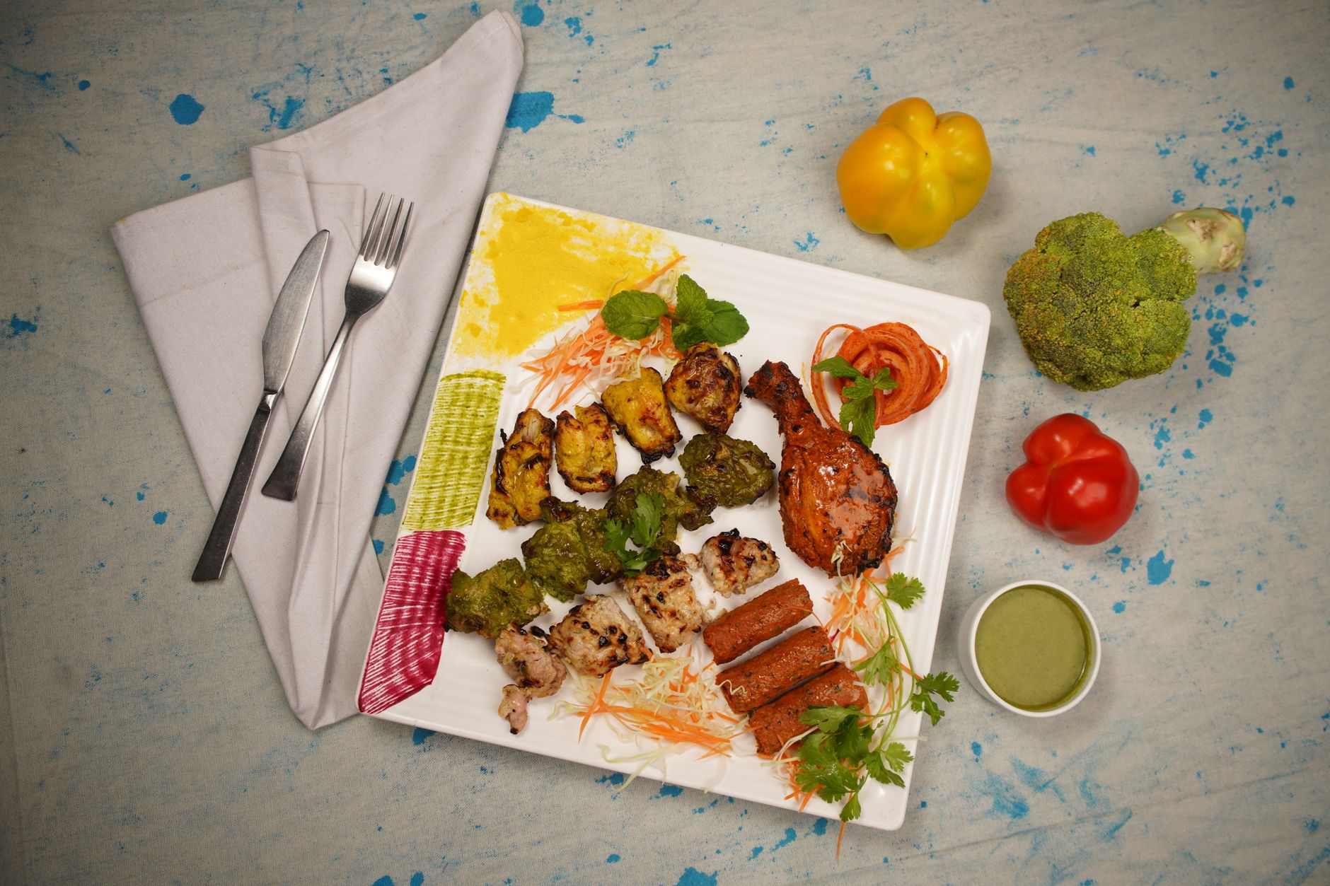 Close-up of crispy roasted tandoori vegetables with herb garnish
