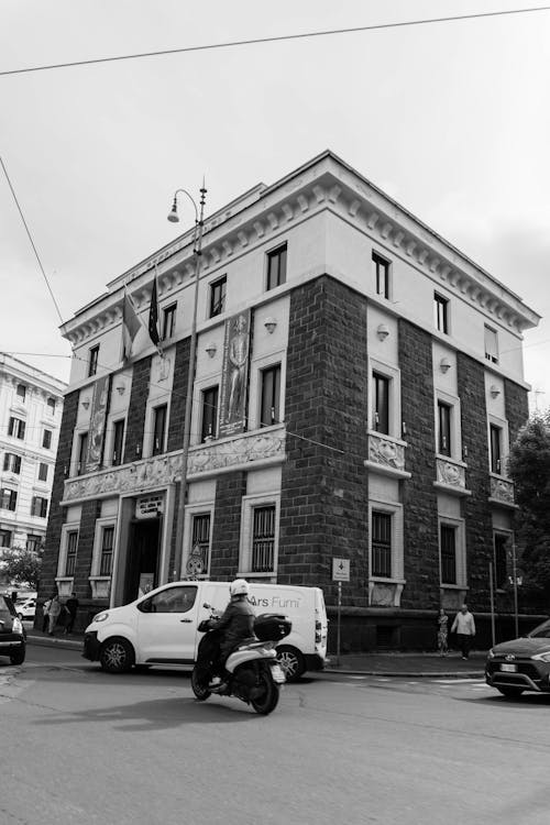 A black and white photo of a building with a motorcycle