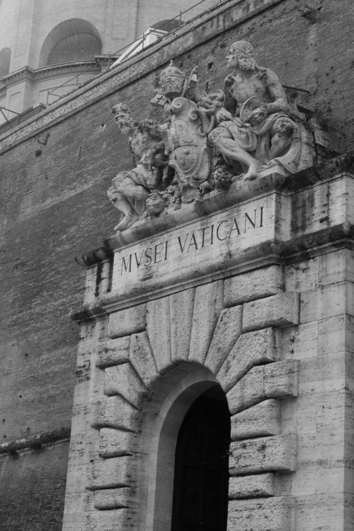 Free Black and white photo of the Vatican Museum entrance showcasing classic architecture and sculptures. Stock Photo