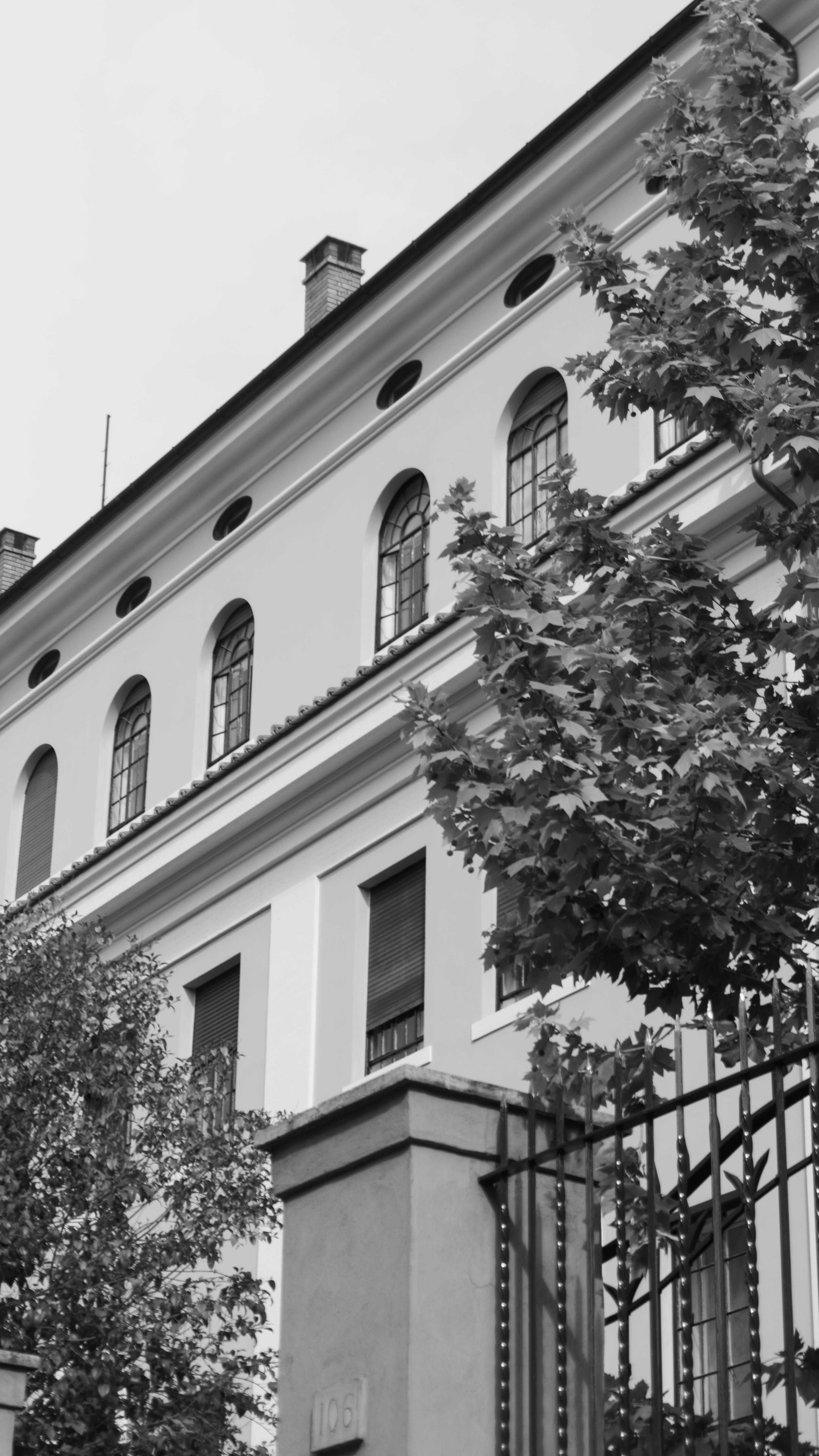 Black and white photo of neoclassical building with trees in Rome, Italy.