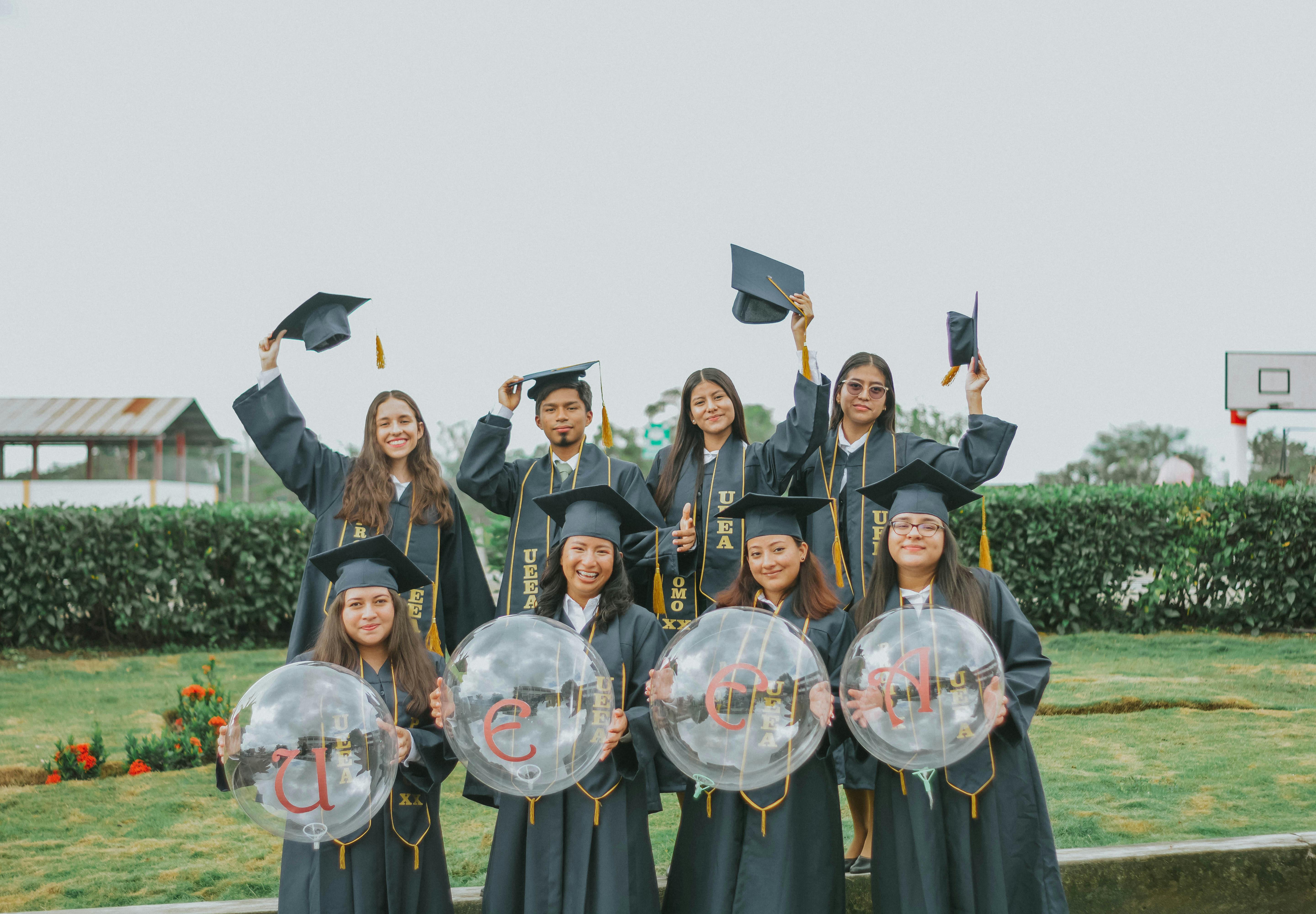Group of students celebrating graduation with mortarboards in Guayaquil, Ecuador.