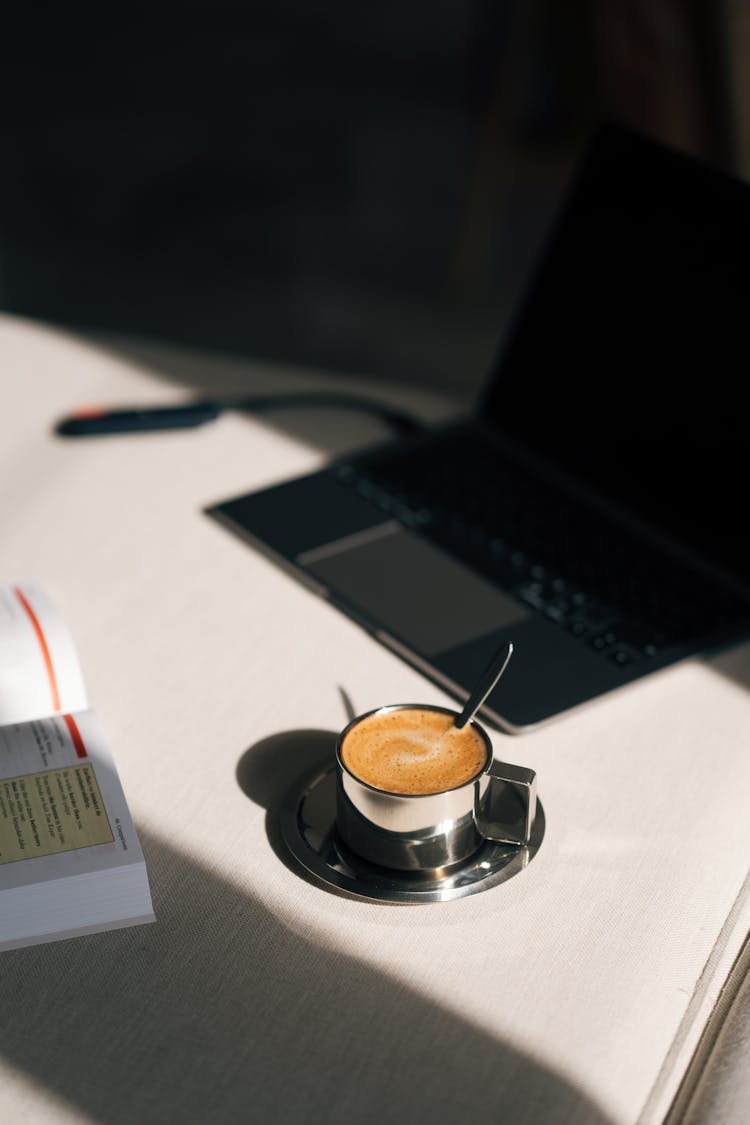 Coffee Cup And Laptop On Desk