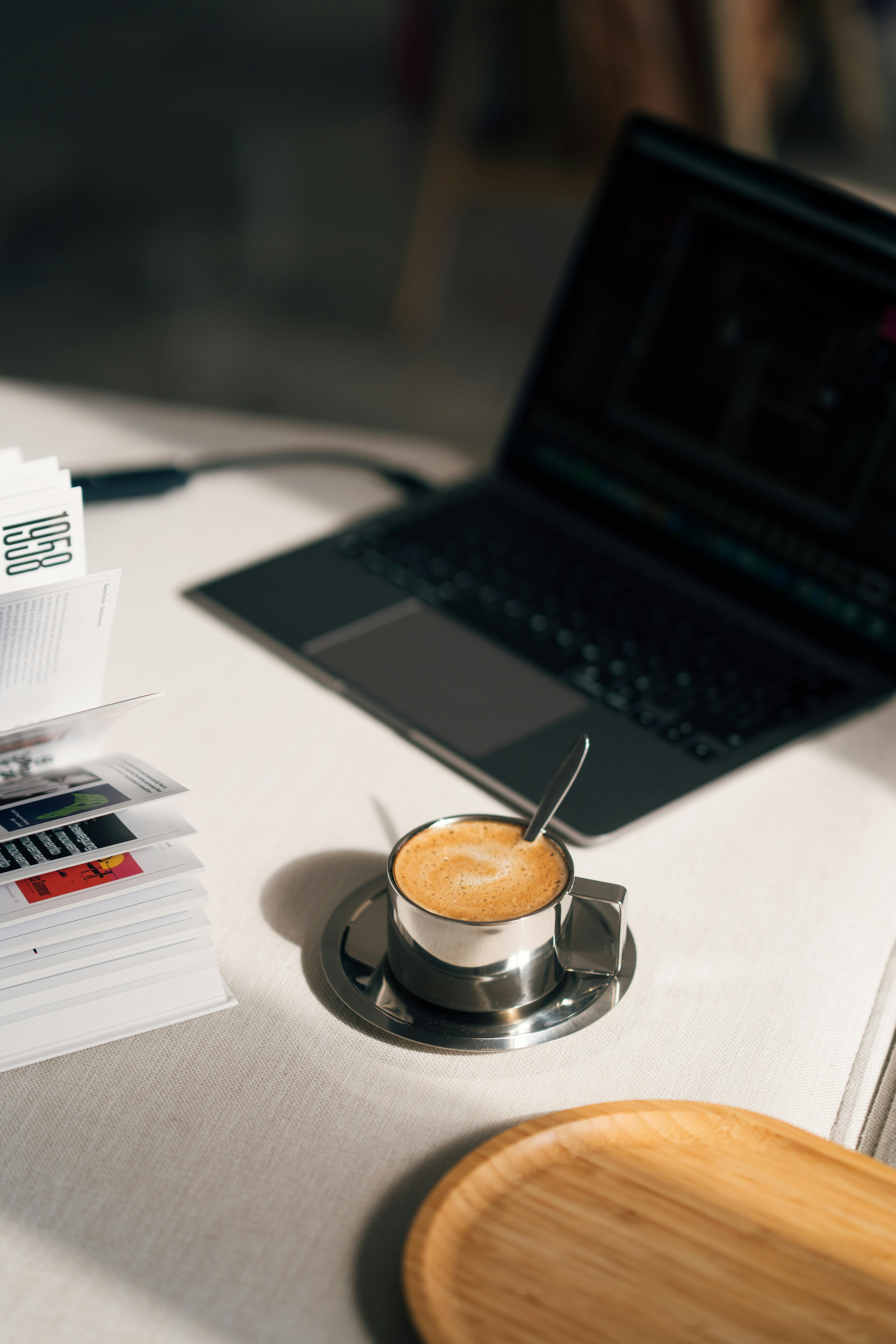 coffee cup and laptop on desk