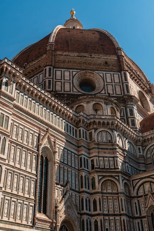 The dome of a cathedral is shown against a blue sky