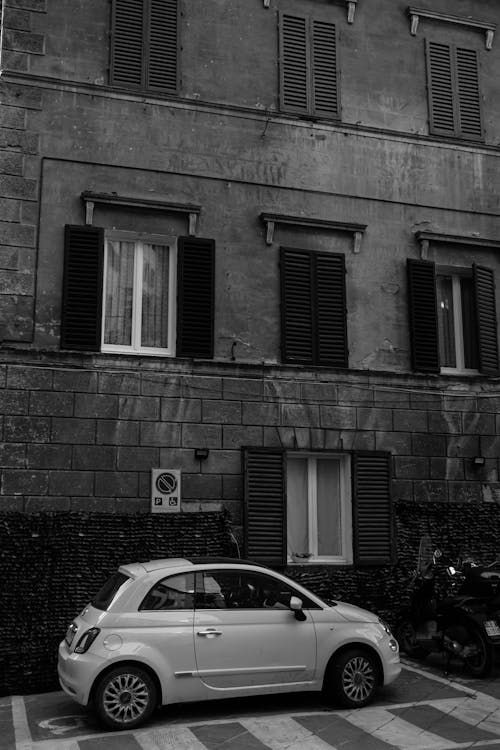 A small car parked in front of a building