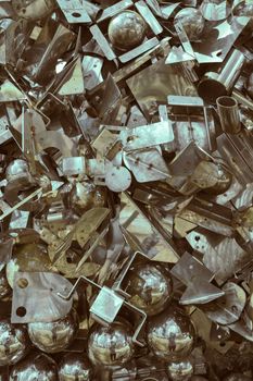 Intricate close-up of assorted metal scrap pieces in Orońsko, showcasing metallic textures and reflections.