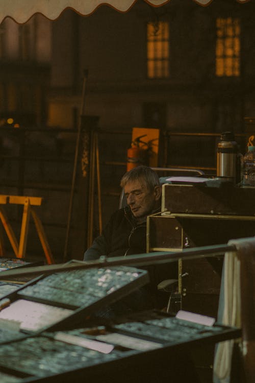 A man sitting at a table with a lamp on