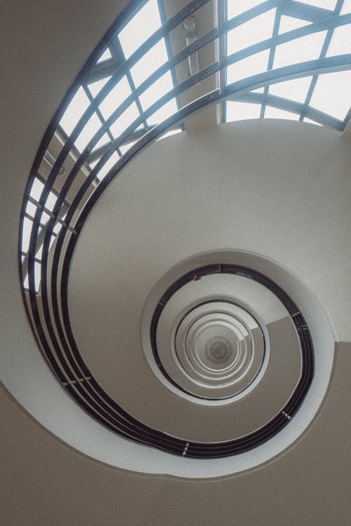 A spiral staircase with a white ceiling