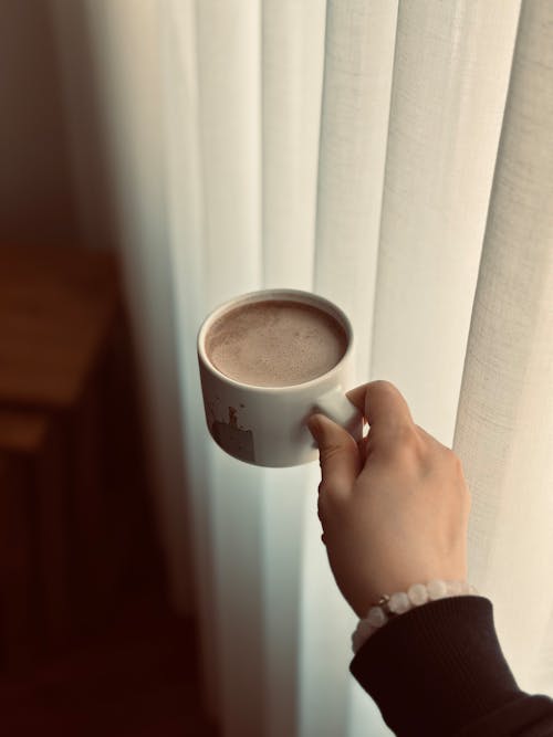 A Person Holding a Coffee 