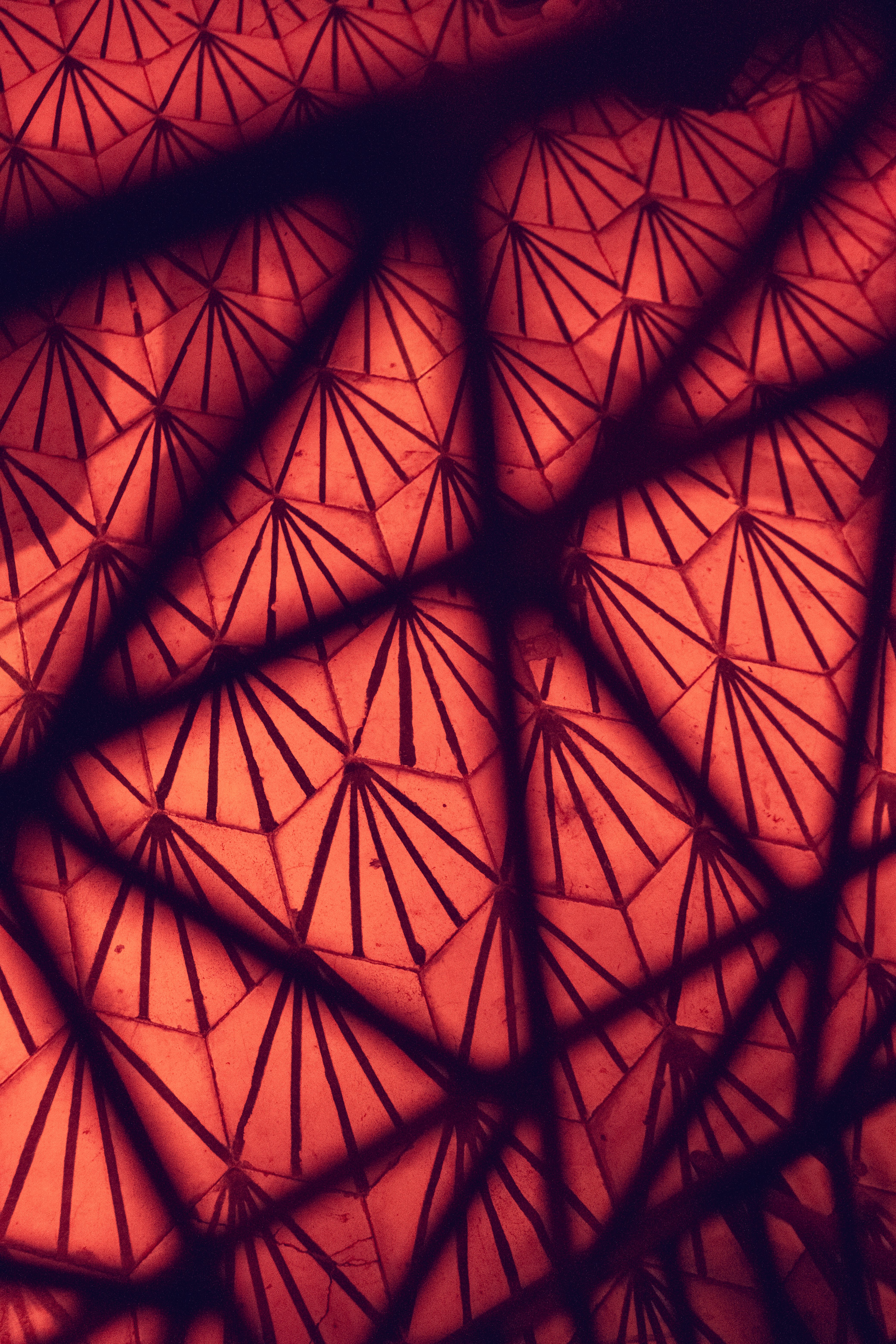 Intriguing geometric patterns with red and black color shades creating an abstract design.