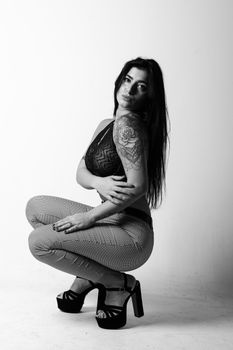Stylish black and white studio photo of a woman in high fashion.