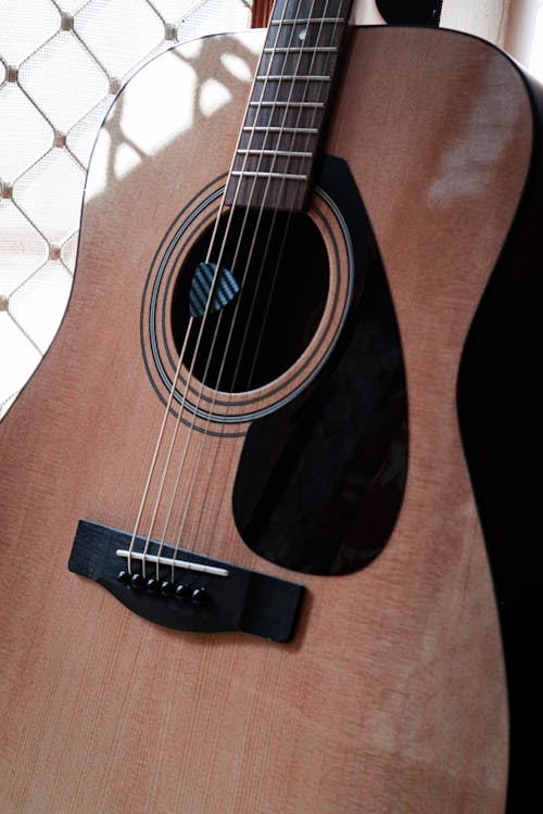 Free Guitar with a Plectrum Between the Strings Stock Photo