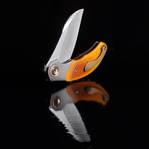 Foto profissional grátis de bem, cabo laranja, canivete