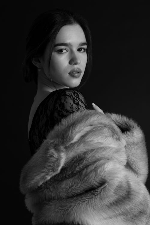 A woman in black and white with a fur coat