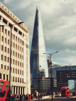 Urban scene featuring The Shard amid classic London architecture and iconic red buses.