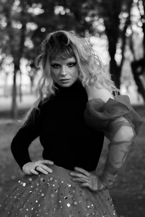 A woman in a skirt and top posing for a photo