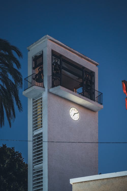 Contemporary Building with a Clock in City at Night 