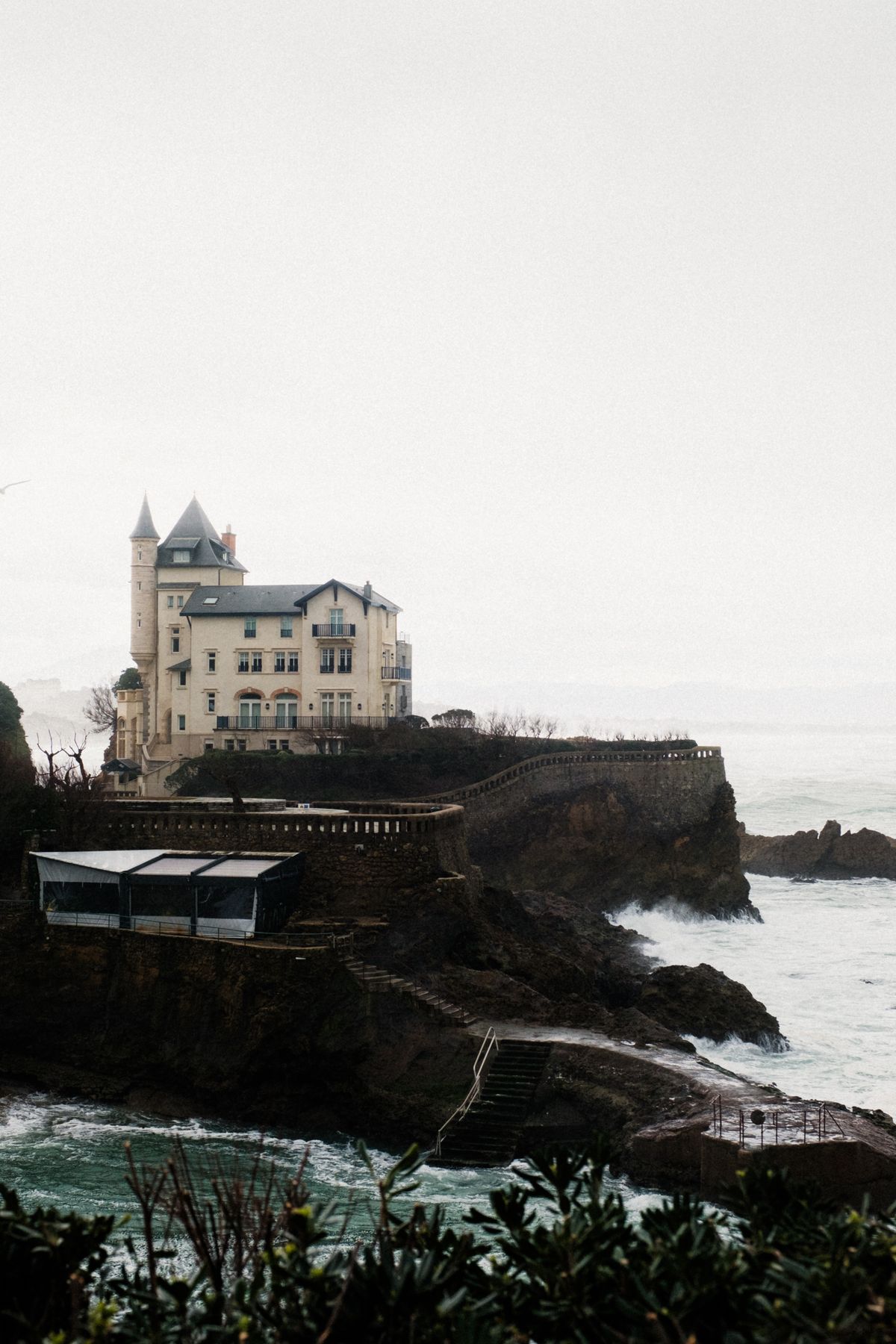Villa Belza on its rocky spur above crashing waves