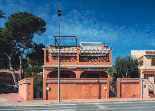 A house with orange walls and a balcony
