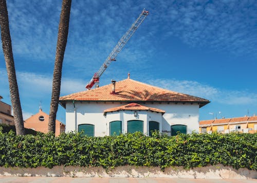 A house with a crane in the background
