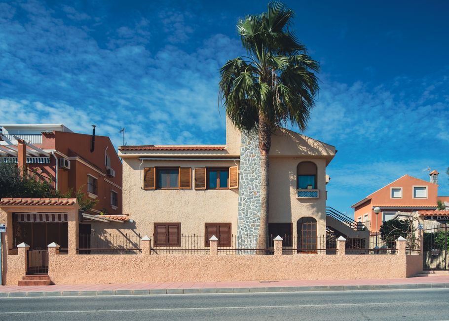 Beautiful Mediterranean house in San Javier, Spain with a striking palm tree in front.