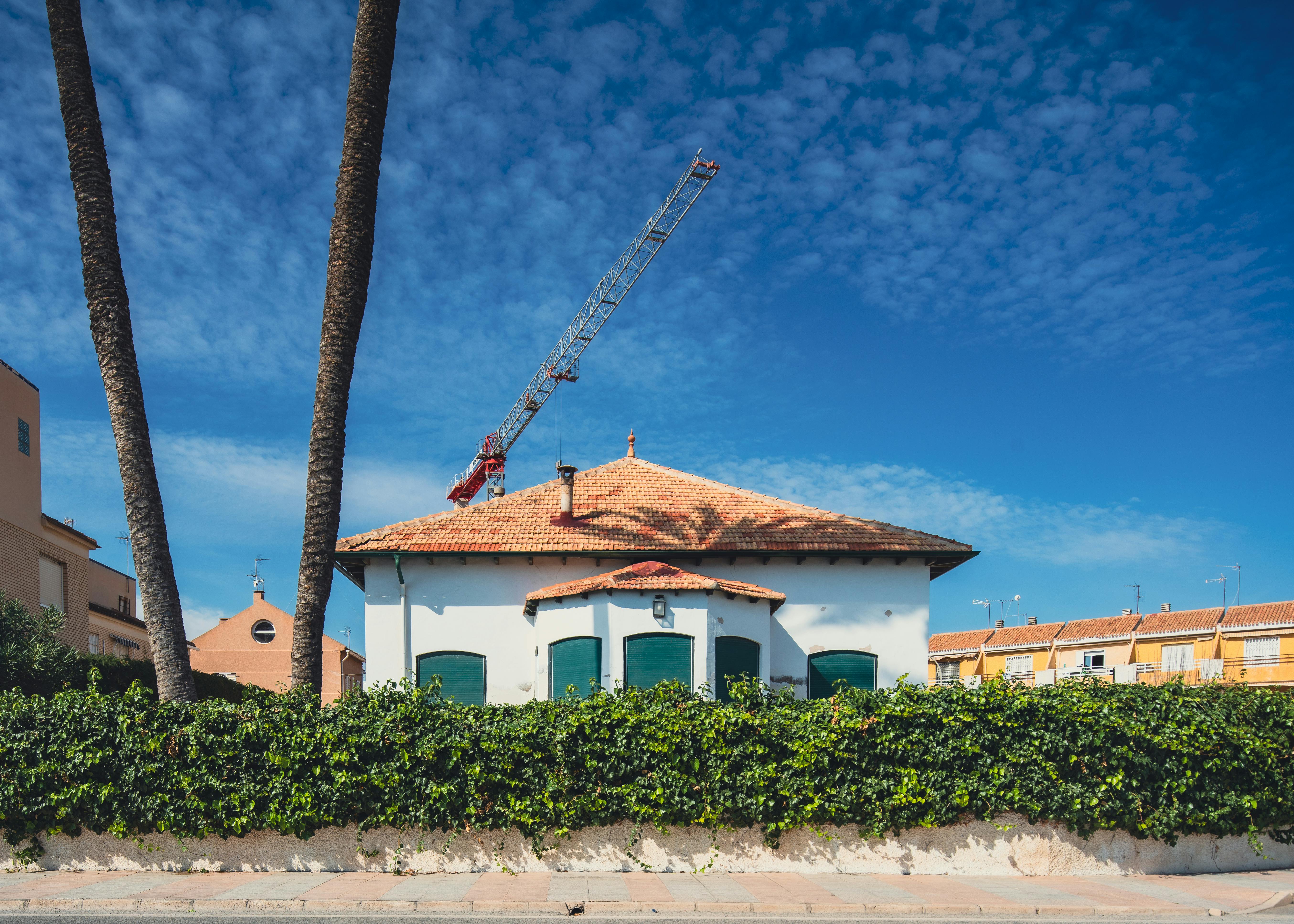 Charming Spanish houses with palm trees and a clear blue sky in San Javier, Spain.