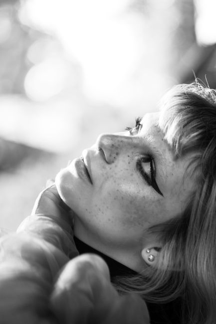 Elegant black and white side profile portrait of a serene woman.