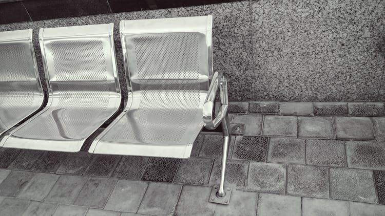 Stainless Steel Bench On Top Of Gray Pavement