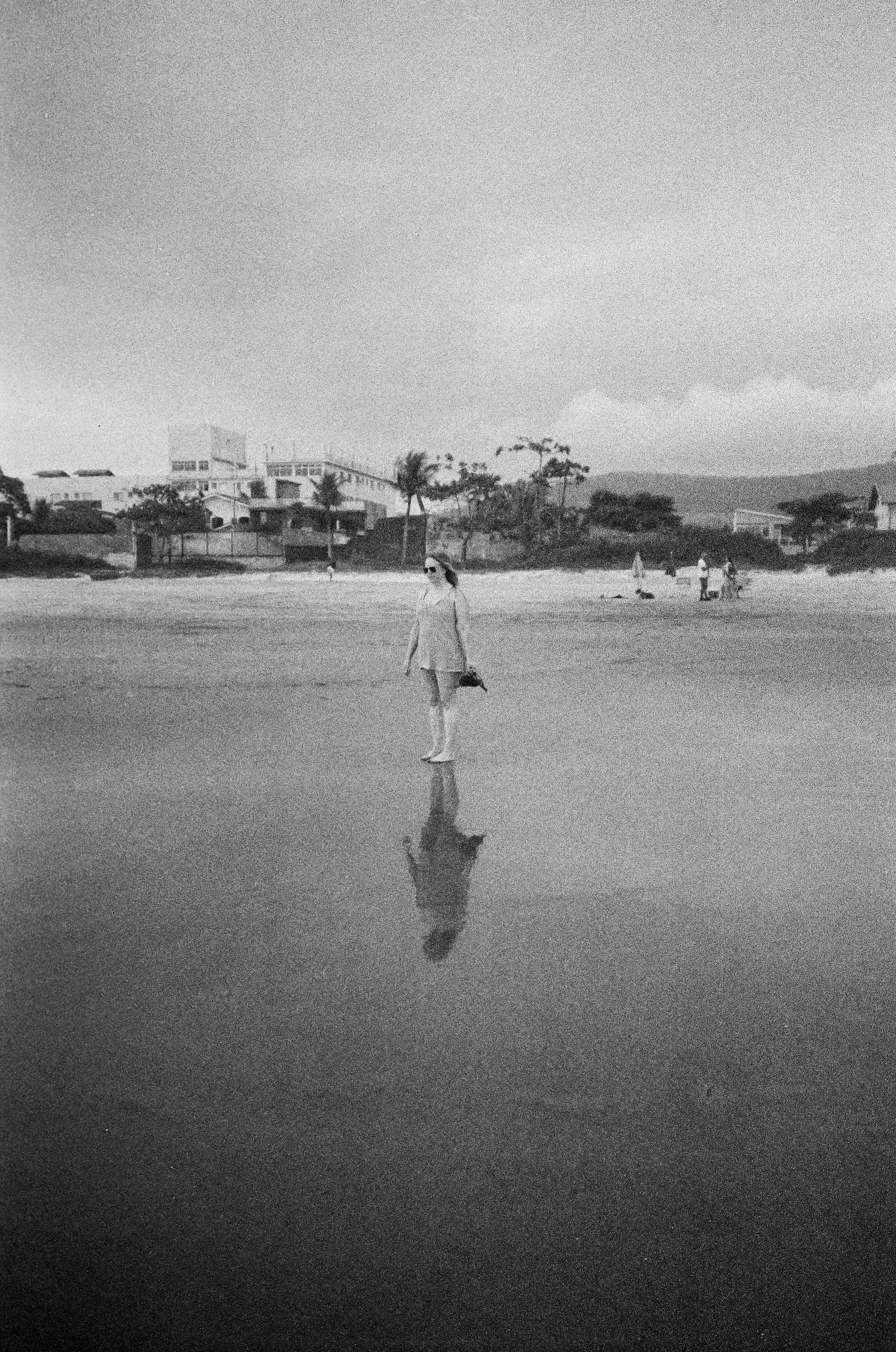 Woman Standing on Beach in Black and White · Free Stock Photo