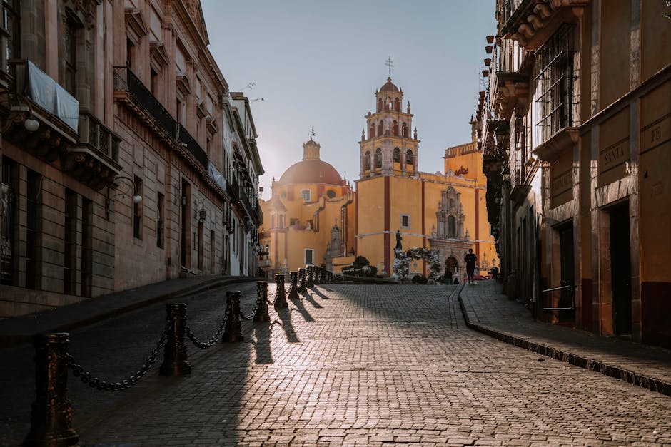 Scenic view of Guanajuato's cobblestone streets and historic church at sunrise, Mexico.