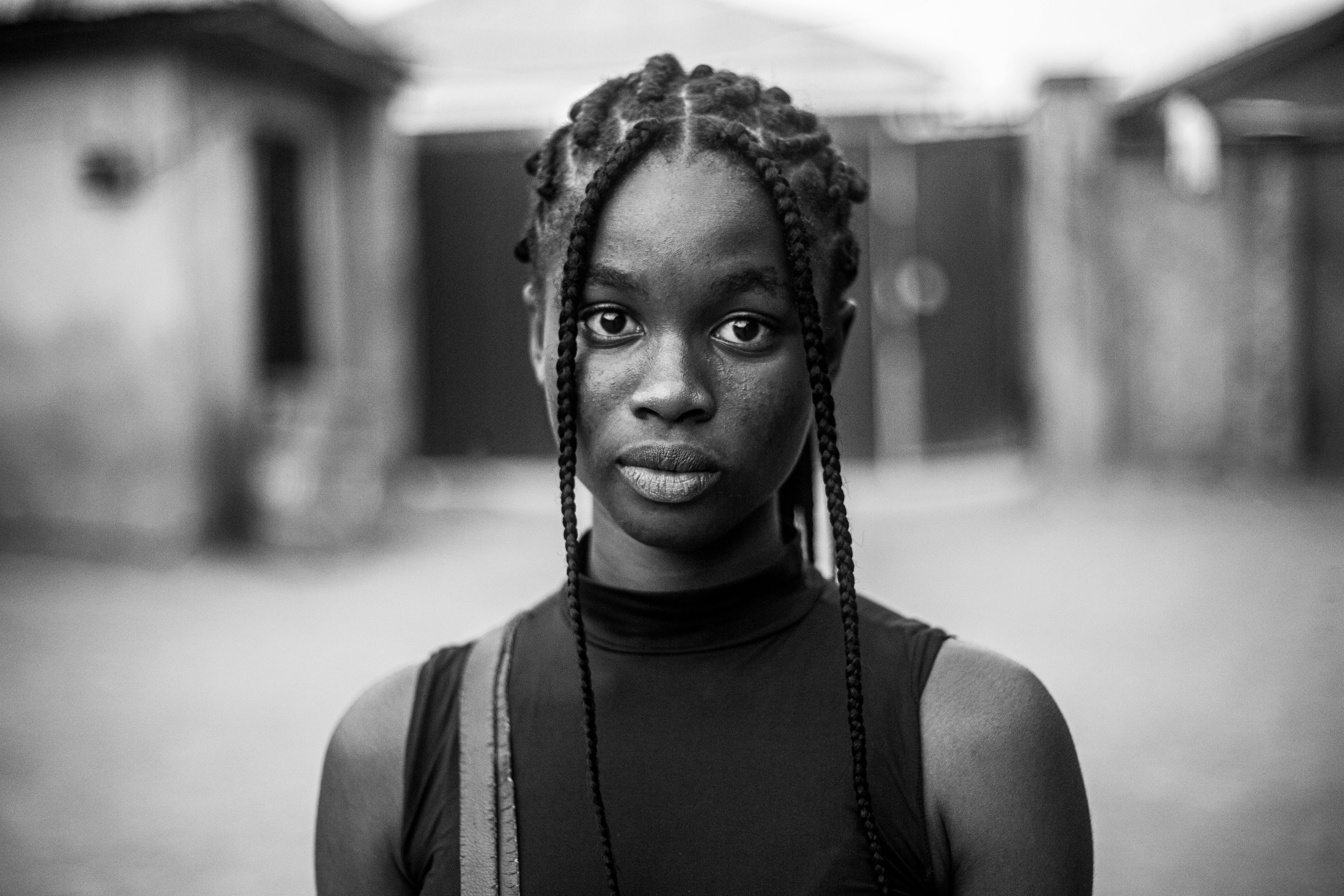 Striking black and white portrait of a young woman with braided hair in Abuja, Nigeria.