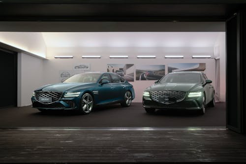 The Genesis G80 and Genesis G80 Sport standing inside an exhibition booth.