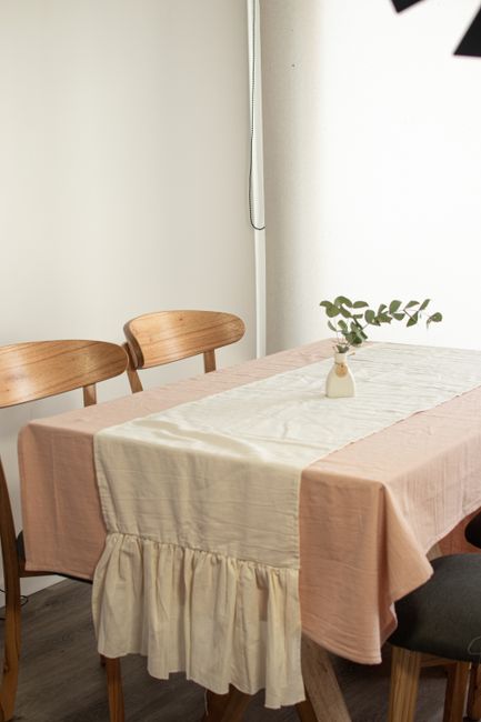A simple and elegant dining room setup featuring a wooden table and chairs with minimalist interior design.
